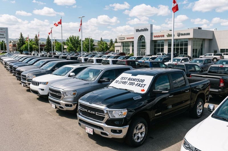Rows of pickup trucks on a Canadian dealership lot with sheets in the windshields