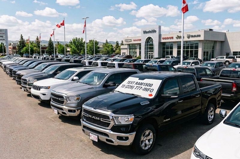A row of pickup trucks on a Canadian dealership lot, window sheets on the windshields